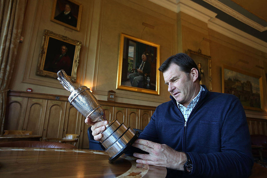 Sir Nick Faldo admires the Claret Jug